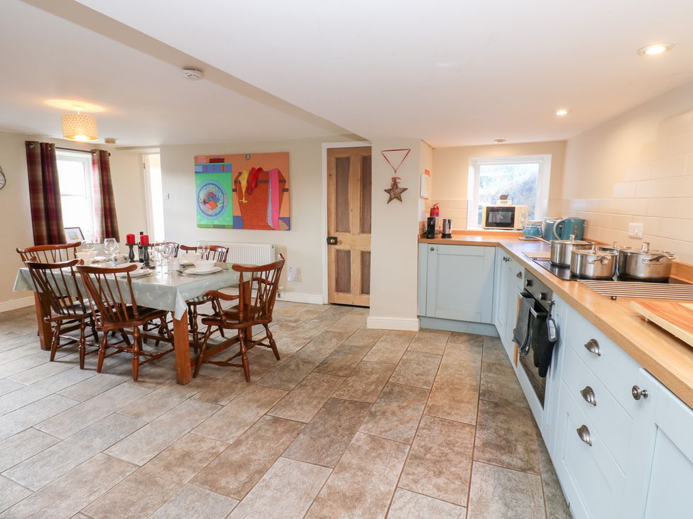 A kitchen with a dining area and countertop at Rosemary Cottage Leyburn