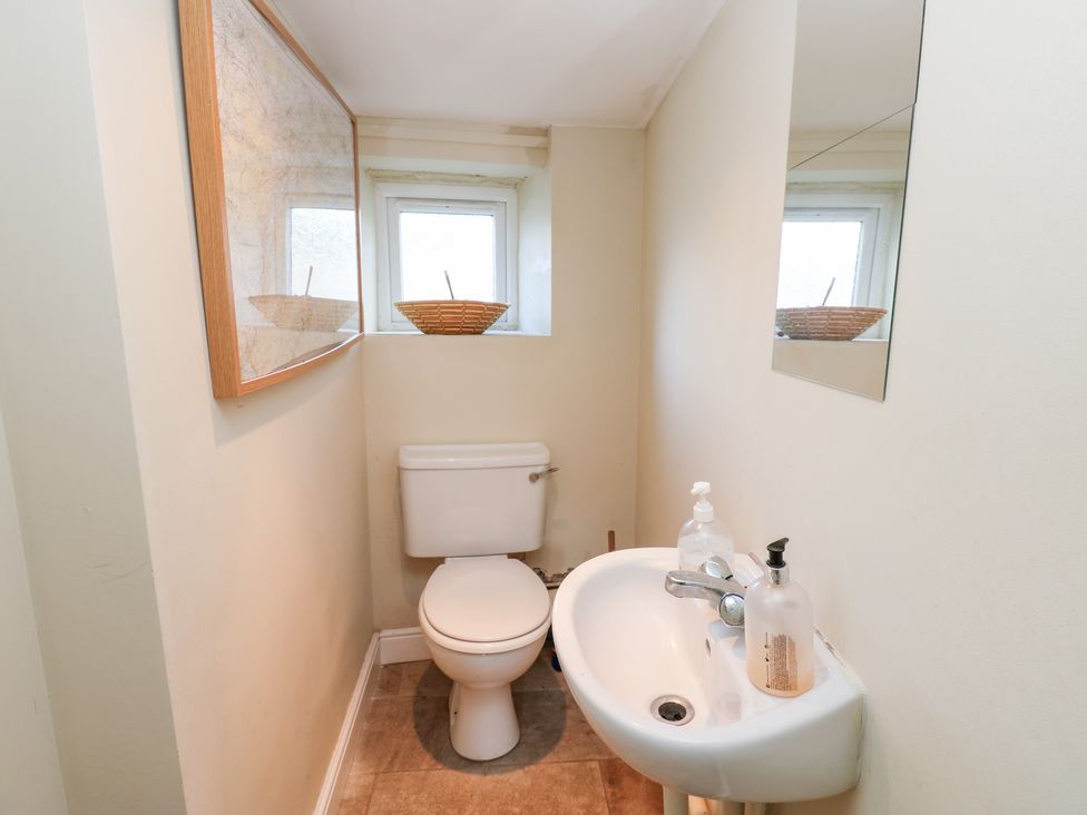 A bathroom with a toilet and sink at Rosemary Cottage Leyburn