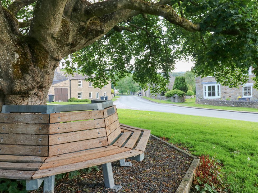 A bench under a tree by the road at Rosemary Cottage Leyburn