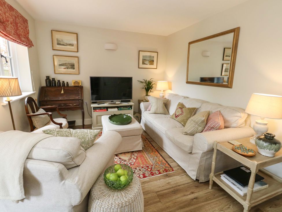 A living room with a sofa and television at 31 Bull Lane Dorchester
