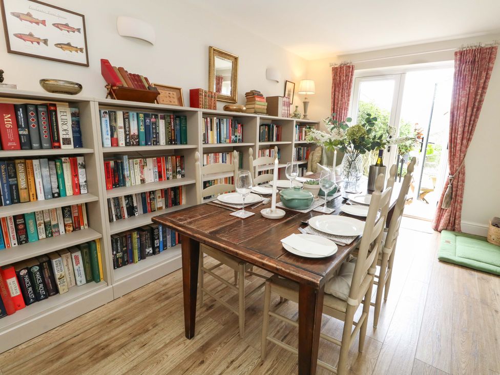 A dining room with a table set for meals at 31 Bull Lane, Dorchester