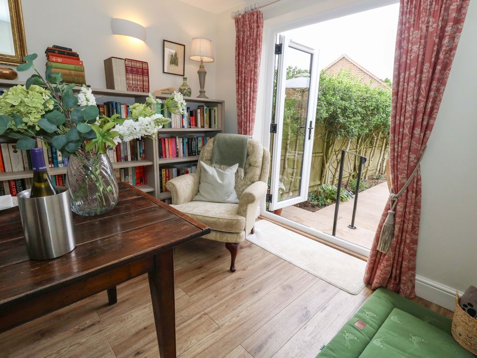 A snug with a bookshelf and a chair at 31 Bull Lane in Dorchester