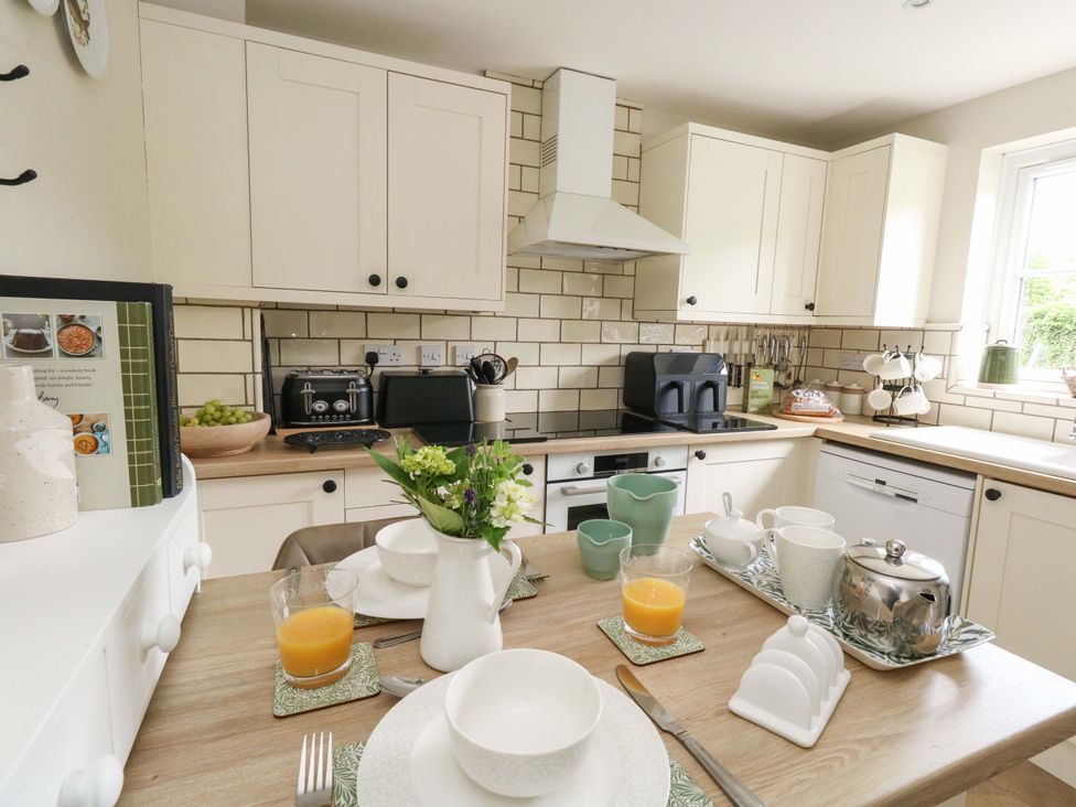 A kitchen with a dining table set at 31 Bull Lane in Dorchester