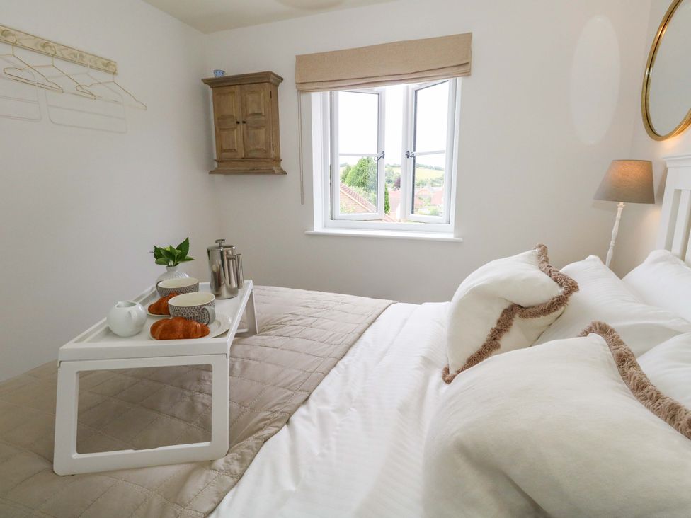 A bedroom with a bed and a tray of food at 31 Bull Lane in Dorchester