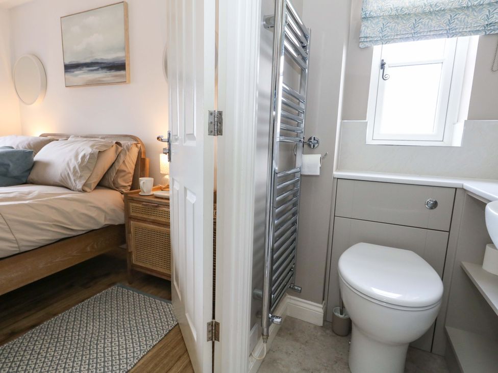 A bedroom with an adjoining bathroom at 31 Bull Lane Dorchester