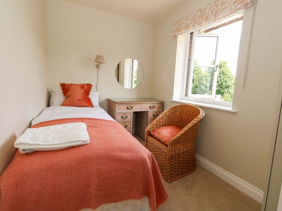 A bedroom with a bed, desk, chair and window at 31 Bull Lane Dorchester