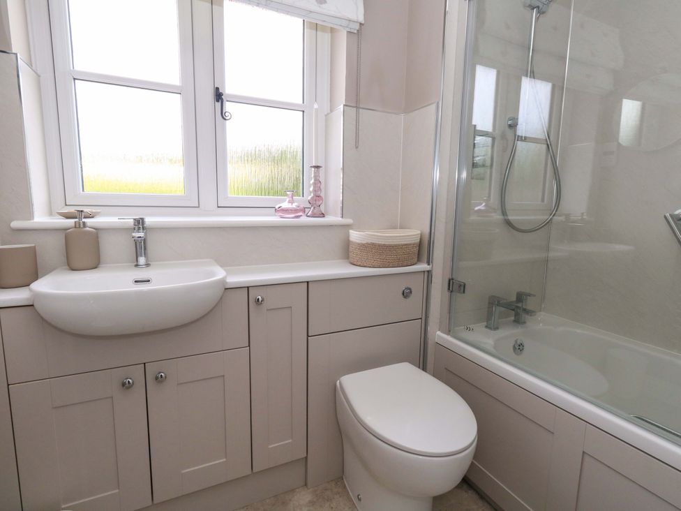 A bathroom with a sink, toilet, and shower at 31 Bull Lane Dorchester