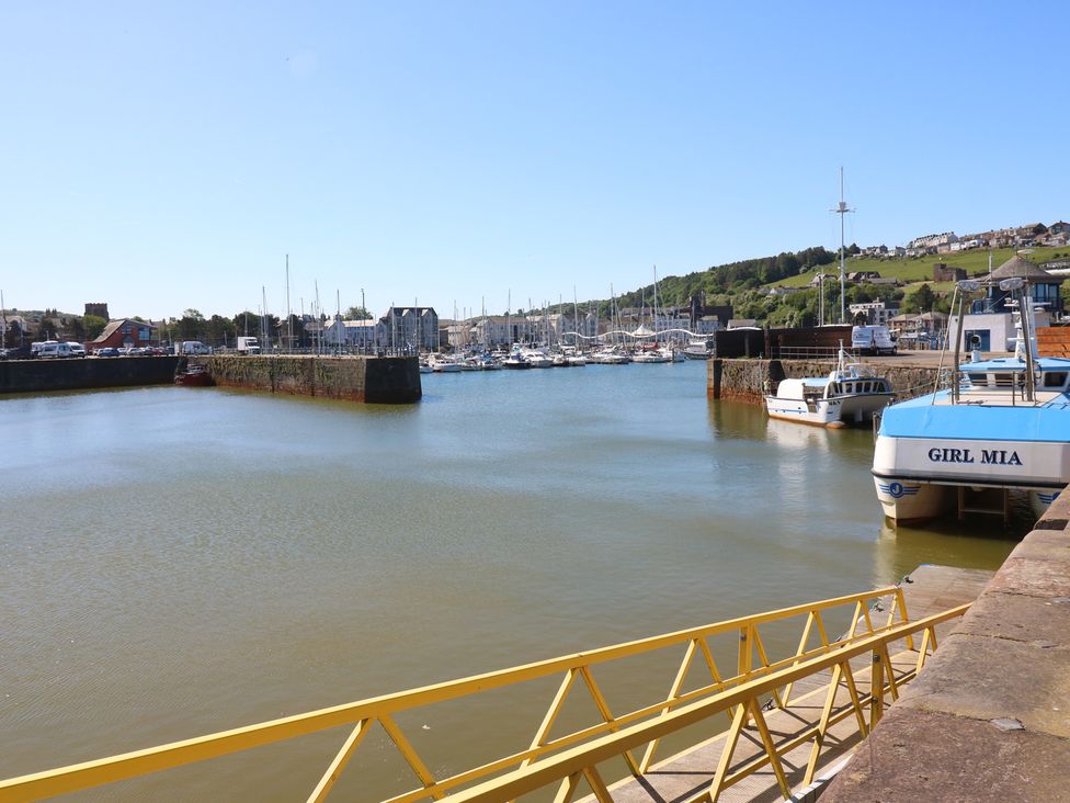 A harbor with boats and a pier at Quayside Apartments in Whitehaven