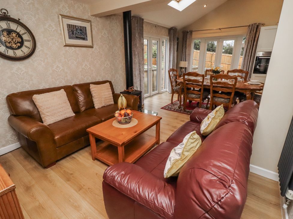 A living room with sofas and a coffee table at 26 Blakelaw Court in Alnwick