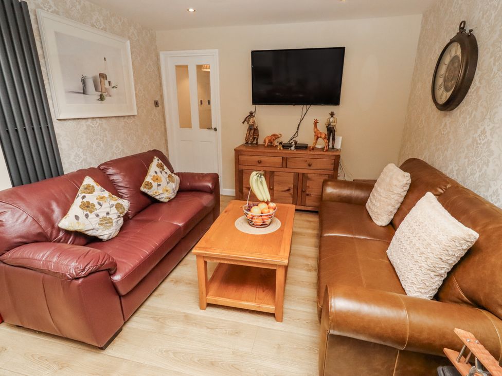 A living room with seating and a television at 26 Blakelaw Court in Alnwick
