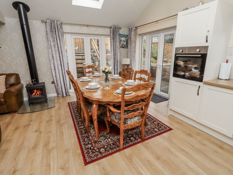 A dining room with a table and chairs at 26 Blakelaw Court in Alnwick