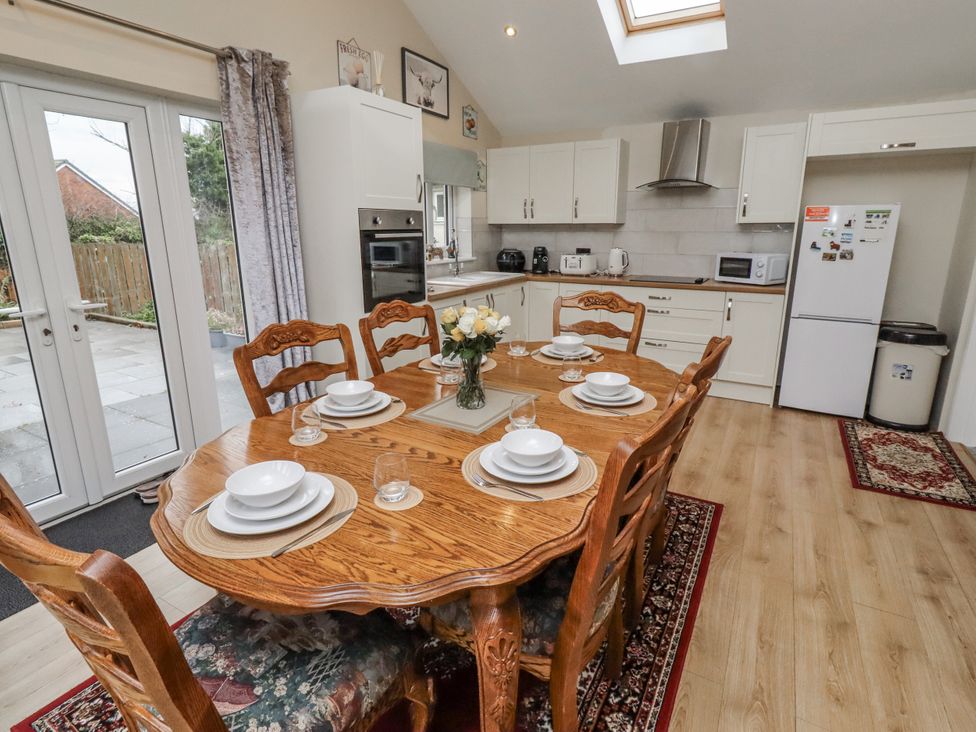 A kitchen with a dining table set for six at 26 Blakelaw Court in Alnwick