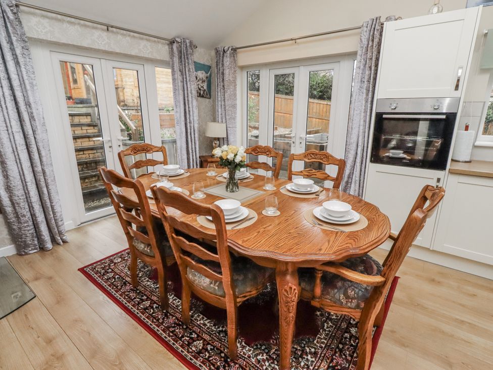 A dining room with a table and chairs at 26 Blakelaw Court in Alnwick