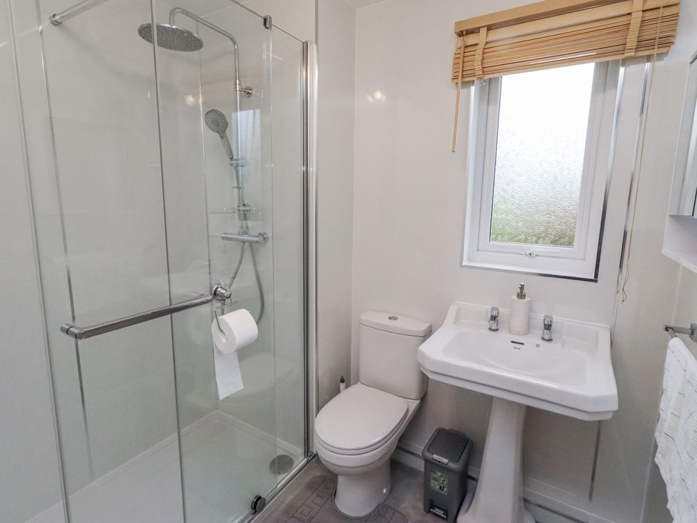 A bathroom with a shower and sink at 26 Blakelaw Court in Alnwick