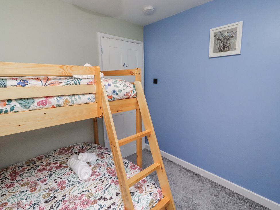 A bedroom with a bunk bed and towels on the lower mattress at 26 Blakelaw Court in Alnwick