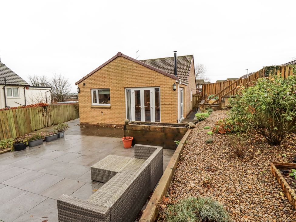 A house with patio furniture and garden at 26 Blakelaw Court in Alnwick