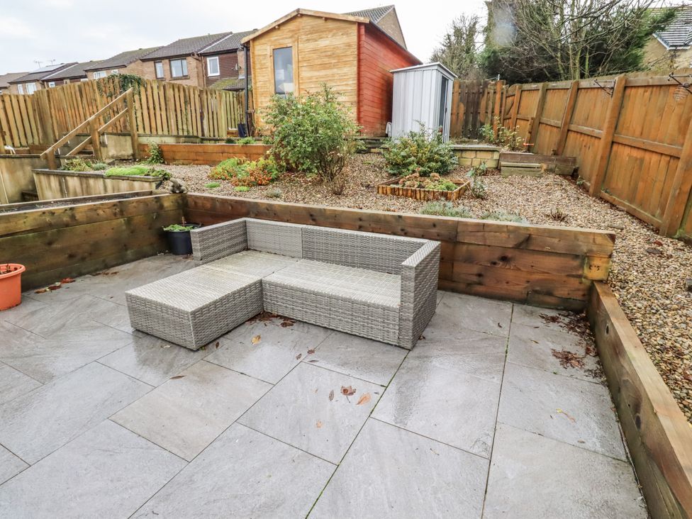 A garden with seating area and shed at 26 Blakelaw Court Alnwick