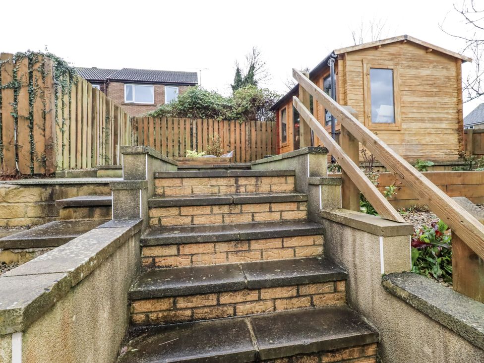 Stairs leading to a wooden cabin in the garden at 26 Blakelaw Court in Alnwick