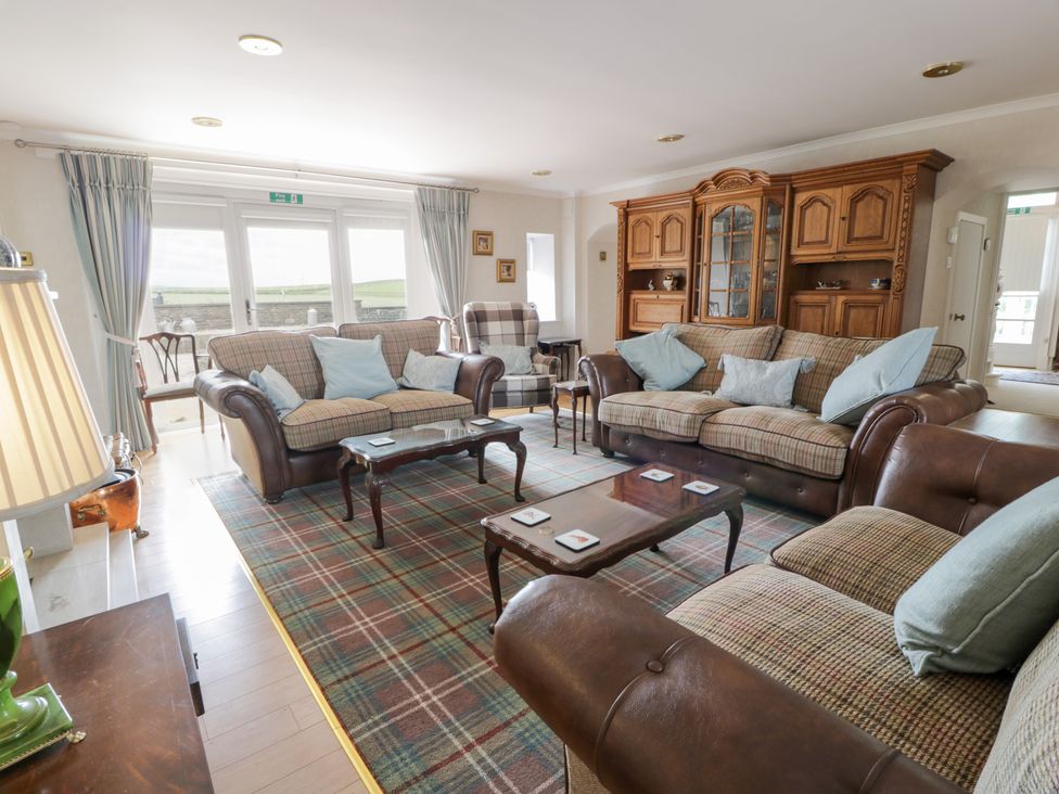 A living room with furniture including sofas and a coffee table at Marshill Farm house in Lanark