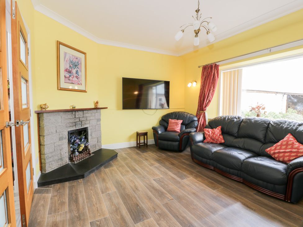 A living room with sofas and a television at Marshill Farm house in Lanark