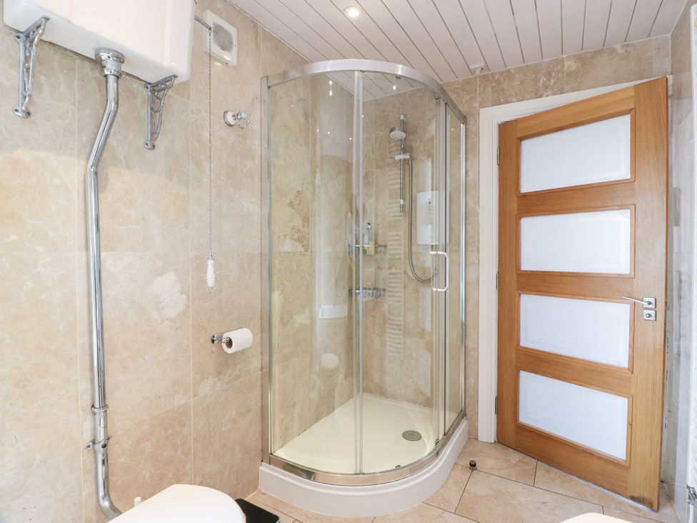 A bathroom with a shower and toilet at Marshill Farm house in Lanark