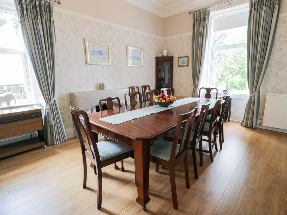 A dining room with a table and chairs at Marshill Farm house in Lanark