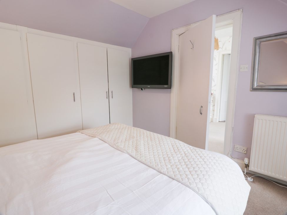 A bedroom with a bed and wardrobe at Marshill Farm house in Lanark