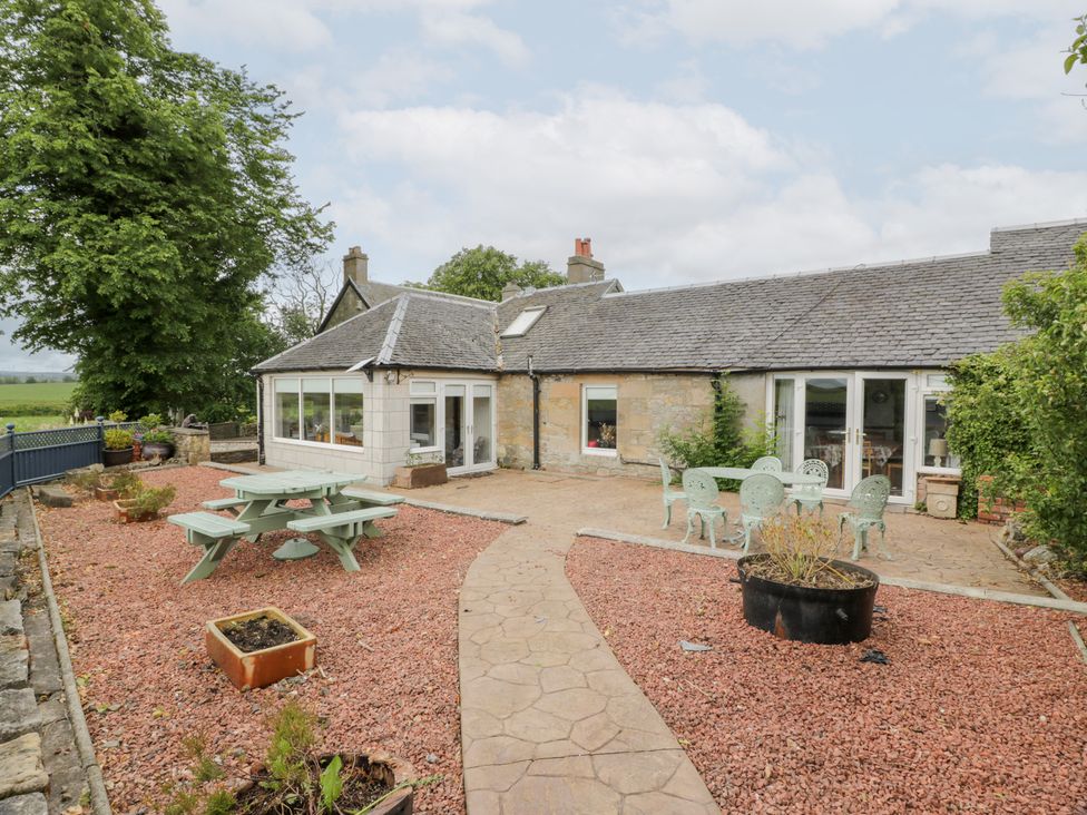 An outdoor area with a garden and patio at Marshill Farm house in Lanark