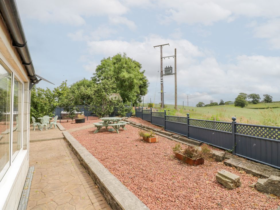 An outdoor area with a table and chairs at Marshill Farm house in Lanark