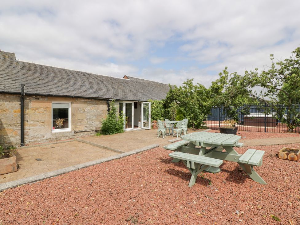 An outdoor area with a table and chairs at Marshill Farm house in Lanark