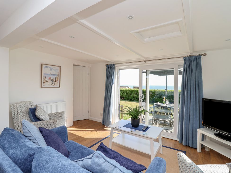 A living room with a sofa and television at Stella Maris in Torpoint