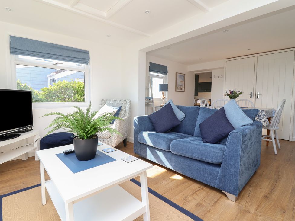 A living room with a sofa and TV at Stella Maris in Torpoint
