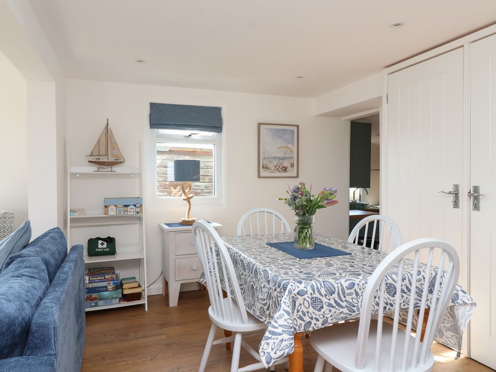 A dining room with a table and chairs at Stella Maris in Torpoint