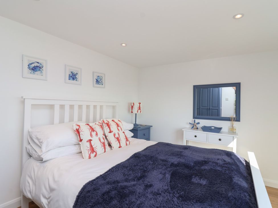 A bedroom with a bed and a blue dresser at Stella Maris in Torpoint