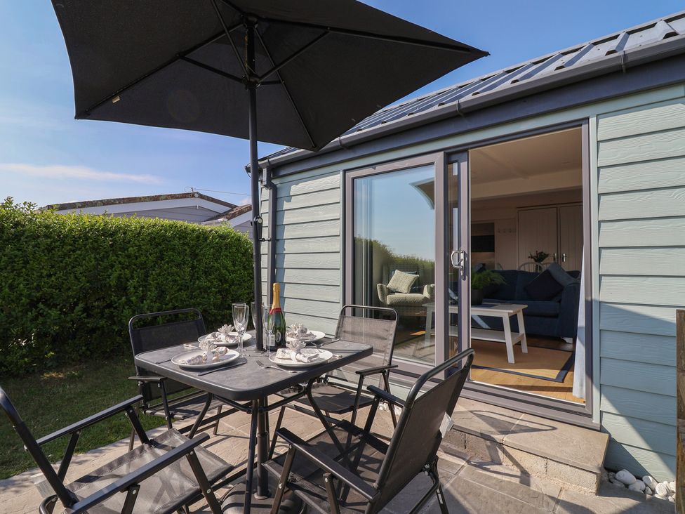 An outdoor seating area with a table and chairs at Stella Maris in Torpoint