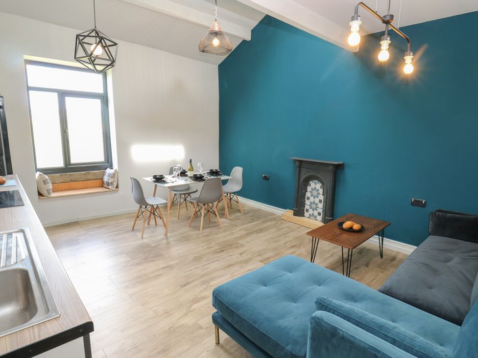 A living room with a dining area and sofa at Myrtle Loft in Keighley