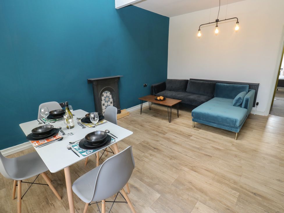 A living room with a dining table and sofa at Myrtle Loft in Keighley