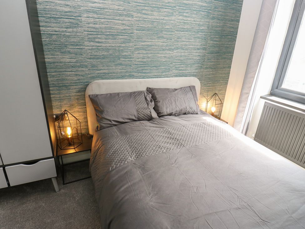 A bedroom with a bed and lamps at Myrtle Loft in Keighley