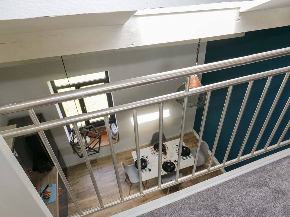 A dining room with a table and chairs at Myrtle Loft Keighley