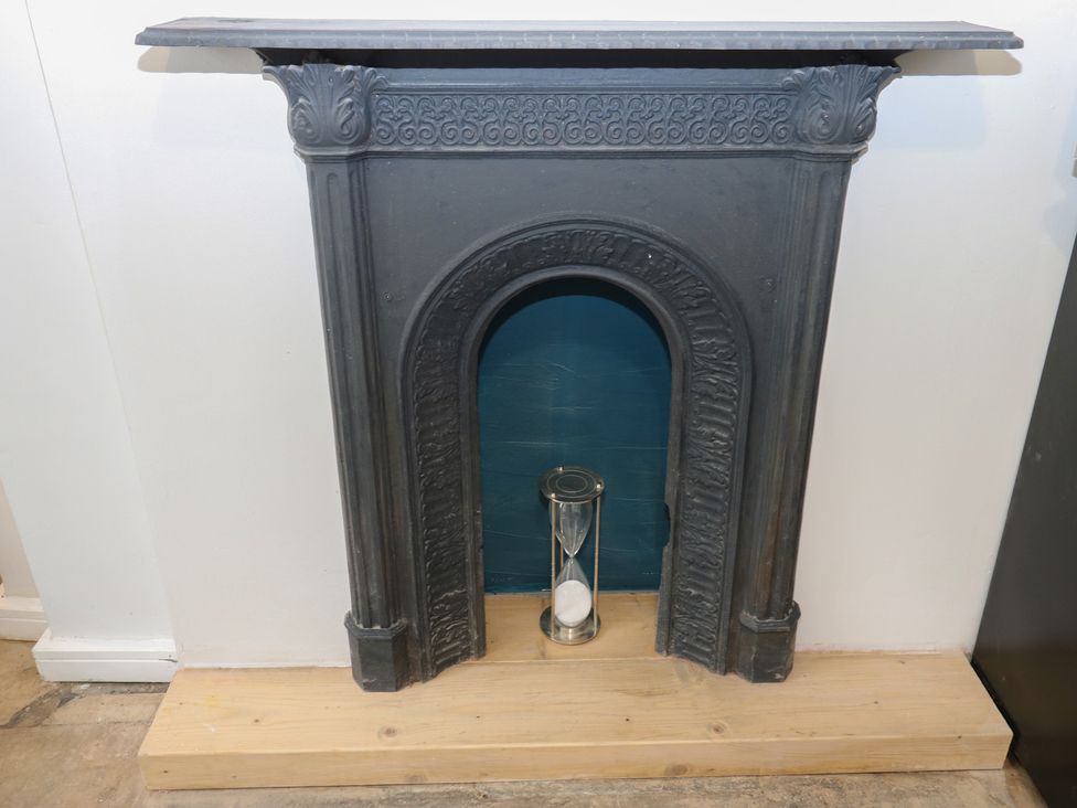 A fireplace with an hourglass at Myrtle Nook in Keighley