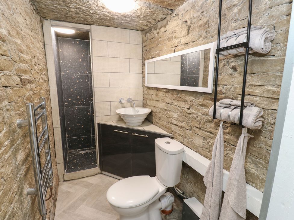 A bathroom with a shower, toilet, and sink at Myrtle Nook in Keighley