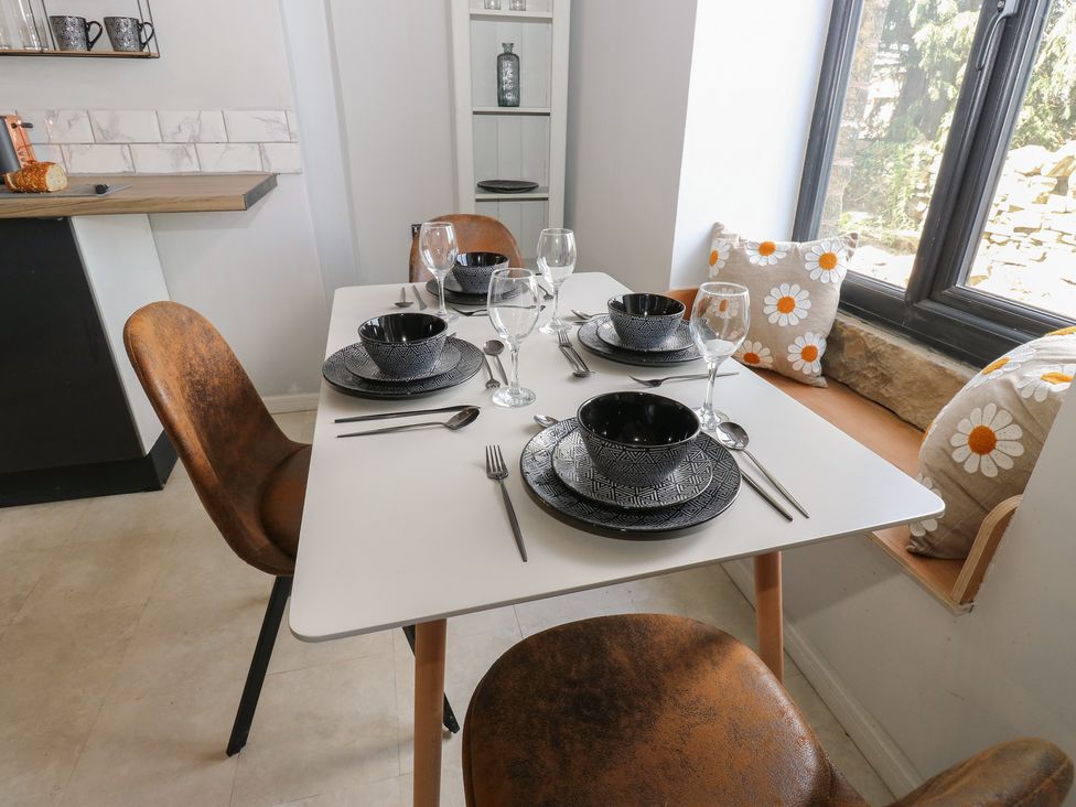 A dining room with a table set for dinner at Myrtle Vista in Keighley