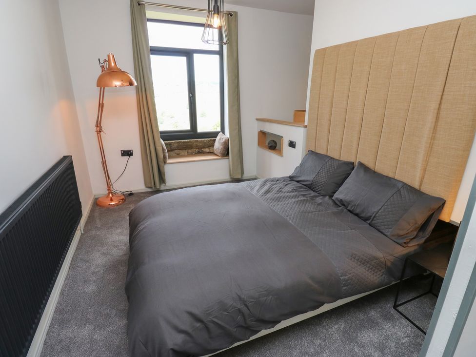 A bedroom with a bed and window at Myrtle Vista in Keighley
