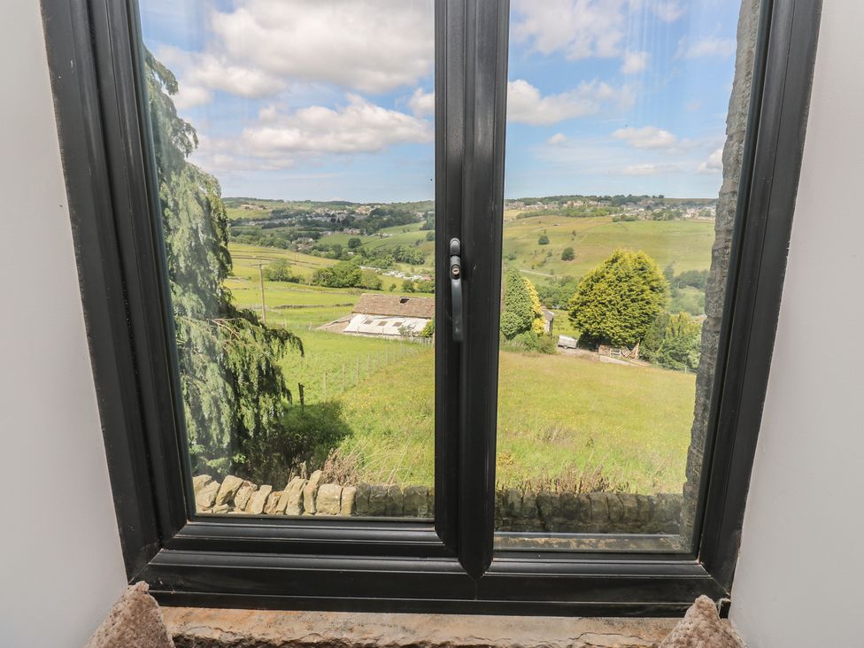 A window view of hills and farmland at Myrtle Vista in Keighley