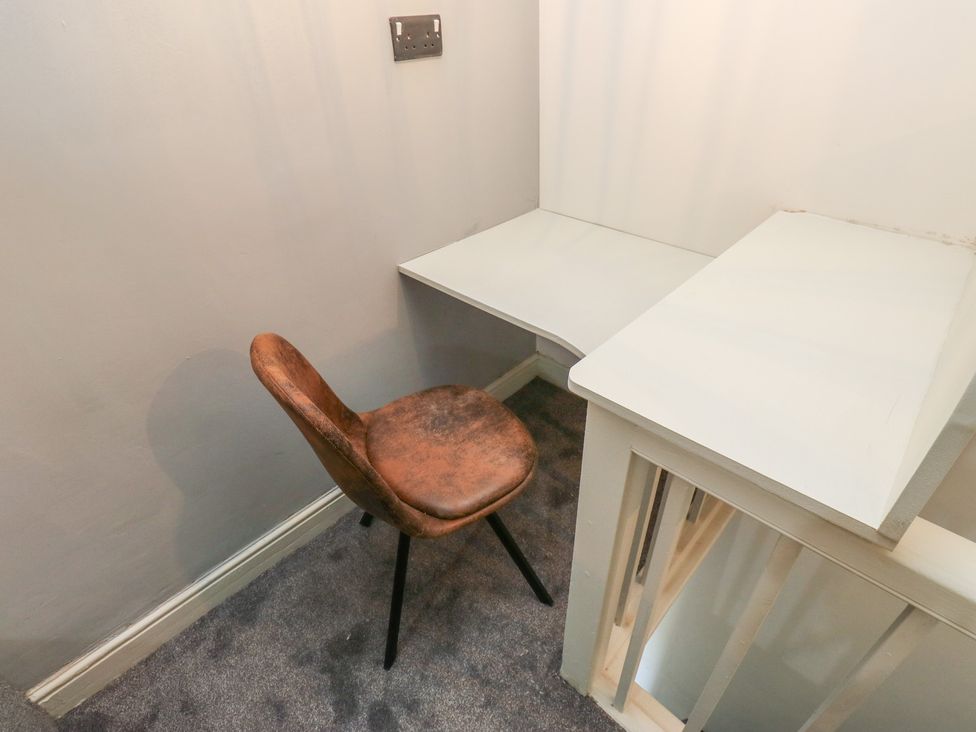 A desk with a chair in a study at Myrtle Vista in Keighley