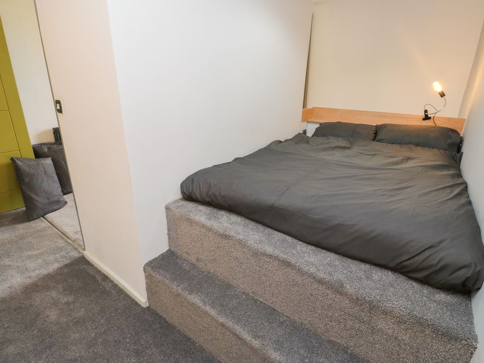 A bedroom with a bed and seating area at Myrtle Vista in Keighley