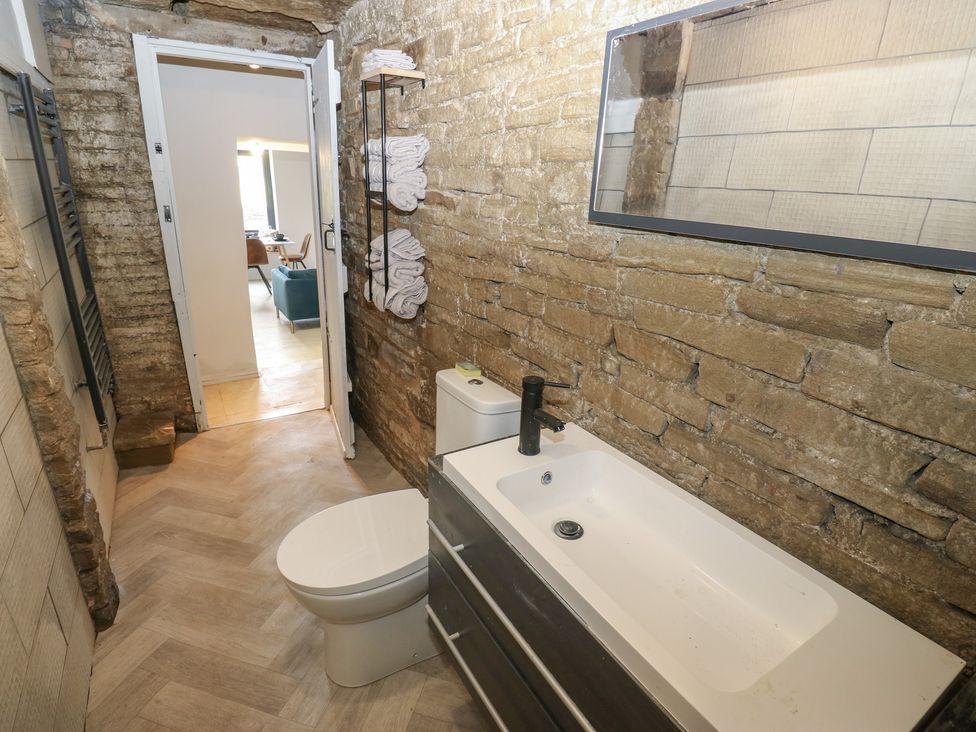 A bathroom with a toilet and sink at Myrtle Vista in Keighley