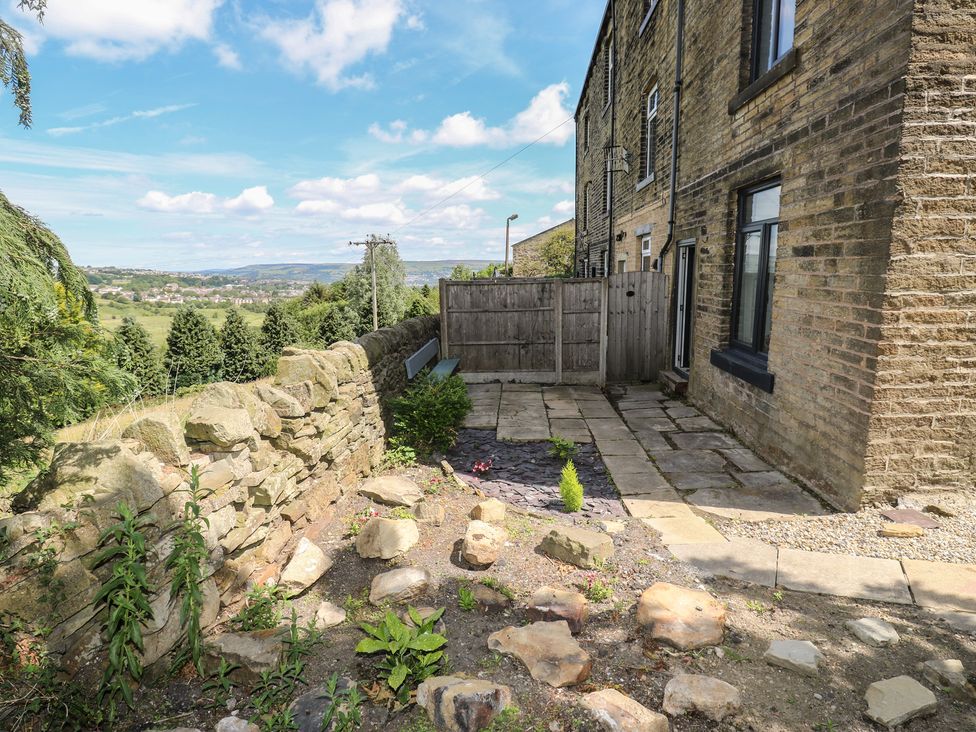 A garden with a stone pathway and plants at Myrtle Vista in Keighley