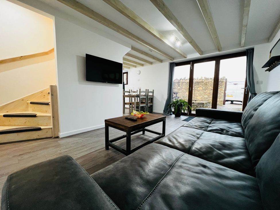 A living room with a sofa and a coffee table at Barn Cottage in Frome