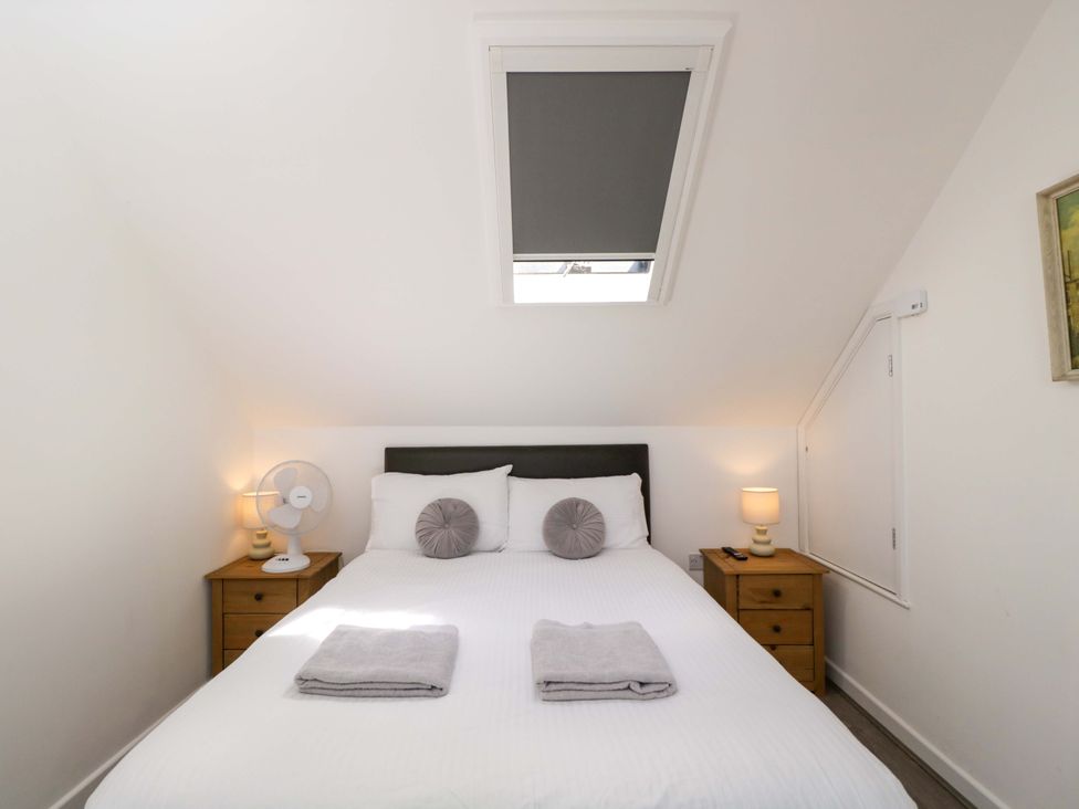 A bedroom with a bed and bedside table at Barn Cottage Frome